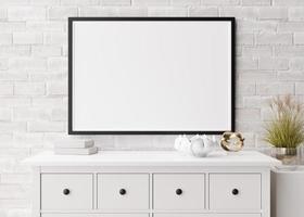 Empty horizontal picture frame on white brick wall in modern living room. Mock up interior in minimalist, scandinavian style. Free, copy space for picture, poster. Console, sculptures. 3D rendering. photo