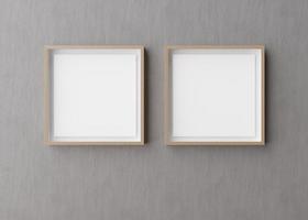 Two blank square picture frames hanging on gray concrete wall. Template, mock up for your picture or poster. Copy space. 3D rendering. photo