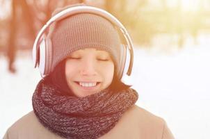 Winter portrait of young girl with headphones photo