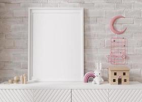 Empty vertical picture frame standing on white sideboard in modern child room. Mock up interior in scandinavian style. Free, copy space for your picture, poster. Close-up view. 3D rendering. photo