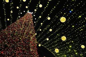Christmas tree glows on the square in the city. Evening, night illumination photo