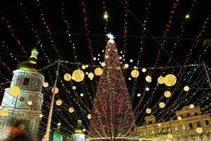 Christmas tree glows on the square in the city. Evening, night illumination photo