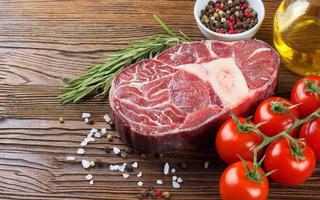 Cooking ingredients. Fresh raw meat beef steak with bone. photo