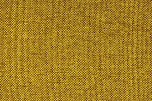 cierre la textura de la tapicería de tejido grueso amarillo. fondo textil decorativo foto