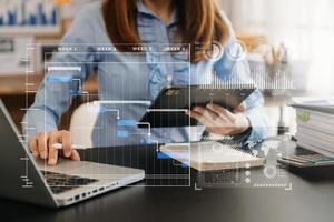 Businessman hand Project manager working and update tasks and Gantt chart scheduling virtual diagram.with smart phone, tablet and laptop in office. photo