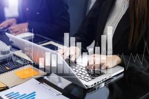 Business documents on office table with smart phone and calculator digital tablet and graph photo