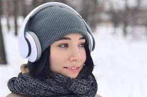 Winter portrait of young girl with headphones photo