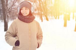 Winter portrait of young girl with headphones photo