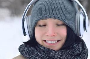 Winter portrait of young girl with headphones photo