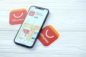 KHARKOV, UKRAINE - MARCH 5, 2021 Aliexpress icon and application from App store on iPhone 12 pro display screen on white table photo