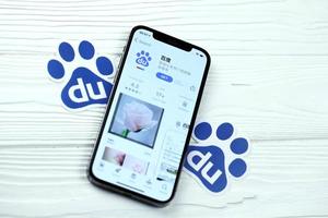 KHARKOV, UKRAINE - MARCH 5, 2021 Baidu icon and application from App store on iPhone 12 pro display screen on white table photo