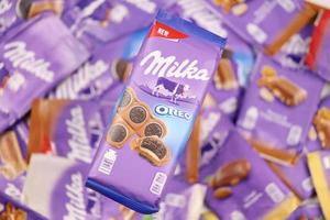 KHARKOV, UKRAINE - DECEMBER 8, 2020 Many wrappings of purple Milka chocolate. Milka is a Swiss brand of chocolate confection manufactured by company Mondelez International photo