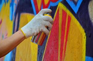 KHARKOV, UKRAINE - MAY 27, 2017 Festival of street arts. Young guys draw graffiti on portable wooden walls in the center of the city. The process of painting on walls with aerosol spray cans photo