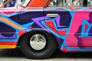 KHARKOV, UKRAINE - MAY 27, 2017 Festival of street art. A car that was painted by masters of street art during the festival. The result of the work of several graffiti artists. Original aerography photo