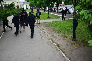 KHARKOV, UKRAINE - MAY 17, 2017 Blocking of exit to police cars by Kharkiv right-wing activists during the breakdown of the LGBT rally in Kharkov photo