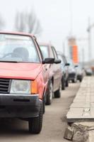 A side view of a car standing near a roadway photo