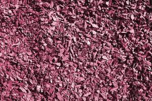 Full frame closeup of brown mulch used for gardening and landscape decoration. Texture of Birch mulch bark for garden. Image toned in Viva Magenta, color of the year photo