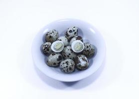 Boiled quail eggs white on white background photo