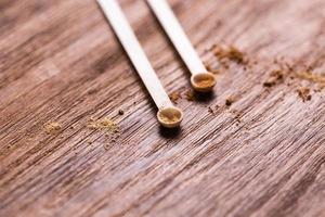 Mineral powder of different colors with a spoon dispenser for make-up on wooden background with copy space photo