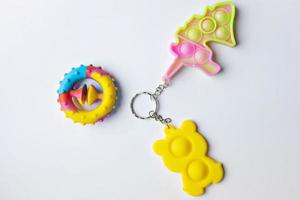 Pop it fidget toy. Multi-colored anti-stress toy with a wing shape on a white background photo
