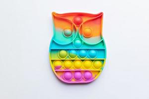 Pop it fidget toy. Multi-colored anti-stress toy with a wing shape on a white background photo