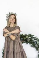 A young woman with blonde hair with a Christmas wreath. New Year's concept,Christmas decorations. photo