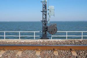 The wire control wheel of the signal post in the railway bridge. photo