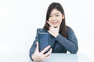 Woman using mobile phone and  writing notebook photo