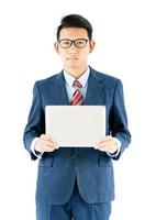 Businessman portrait in suit holding a laptop over white background photo