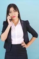 Asian women in suit standing posing using her phone photo