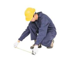 Young worker in unifrom with tape measure isolated on white photo