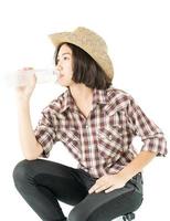 Woman in a plaid shirt holding a water bottle on white background photo