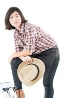 Young woman in a plaid shirt posing in studio on white background photo