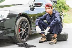 Mechanic replacing lug nuts changing tires on vehicle photo