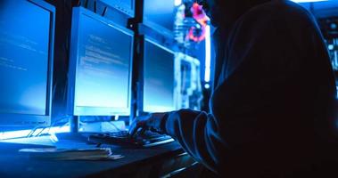 A male hacker is using a computer to hack data to demand ransom from victims. photo
