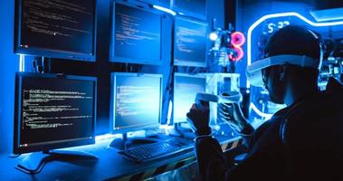 A hacker wearing virtual reality glasses is using computer to hack data to get ransom from victims. photo