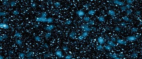 Colorful background blurry snow. Bokeh background with snowflake. Winter glittering snowflakes swirl bokeh background, backdrop with sparkling blue stars. Snowflake winter season. photo
