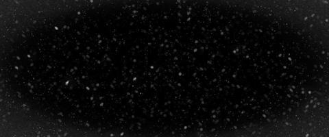 Snowfall bokeh on dark foundation. Numerous snowflakes in flying in the air. Winte night snowfall and snowstorm of snow at. Obscure bokeh light impact innovative foundation photo