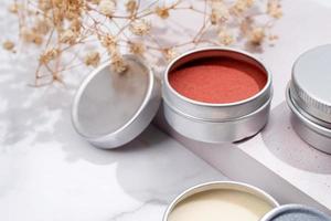 colorful lip balms in round tin cases with shadow overlay, mockup design photo