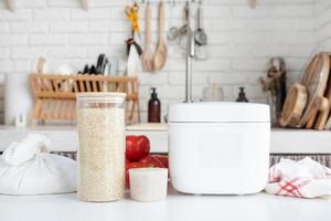 Electric rice cooker on wooden counter-top in the kitchen photo