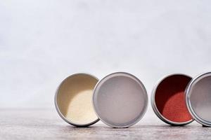 colorful lip balms in round tin cases , mockup design photo