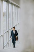 Young business executive with briefcase going up the stairs photo