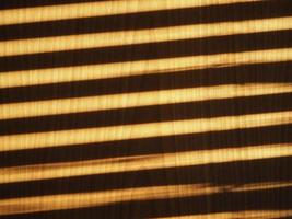 blinds shadow on wooden wall background photo