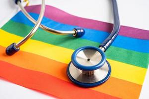 stethoscope on rainbow flag background, symbol of LGBT pride month  celebrate annual in June social, symbol of gay, lesbian, bisexual, transgender, human rights and peace. photo