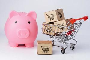 Shopping cart logo on box with piggy bank. photo