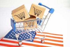 Box with shopping cart logo and USA America flag, Import Export Shopping online or eCommerce finance delivery service store product shipping, trade, supplier concept. photo