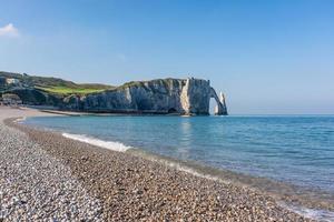 Scenic view of Etretat coast in Normandy France with calm sea against clear blue sky photo