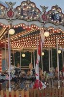 Empty vintage carousel horses during traditional Christmas fairy market, closeup. photo