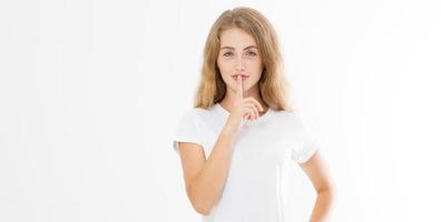 Shhh sign. Young woman showing shh gesture to keep a silent. Girl in template white t shirt keep a secret. Quiet place and silence time. Copy space. Banner photo