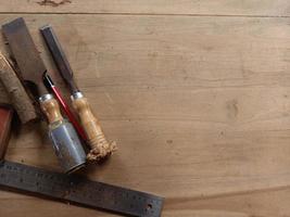 Carpenter wood working tools laying on wooden table. Industrial wood working materials. photo